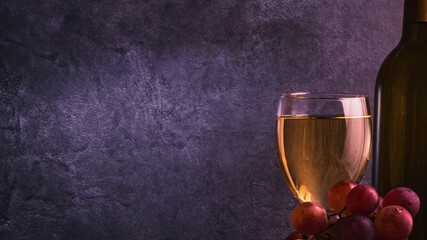 A beautiful still life with wine glasses, a bunch of grapes and a bottle of wine. Calm muted colors.