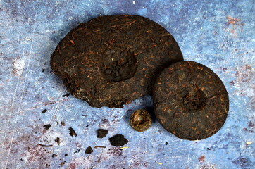Pressed round pancakes and bricks of puer tea of different kinds. Dry Chinese puer tea of high quality.