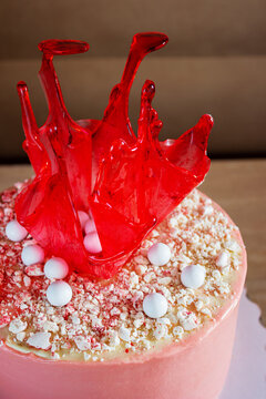 Bright Red Birthday Cake With Caramel Decoration On The Table