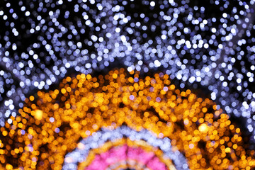 Christmas lights, defocused colorful abstract background. Blurred bokeh with golden, pink and blue...