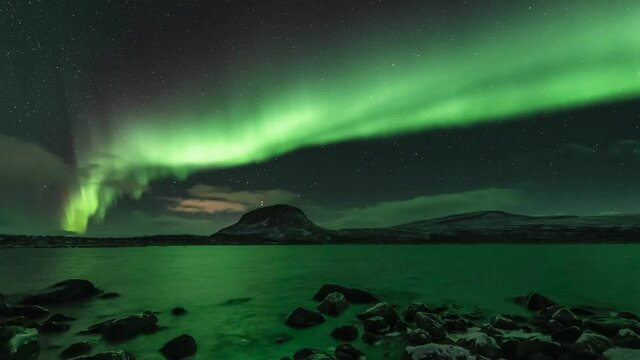 Auroras above a fell in Lapland, tilt down (2)