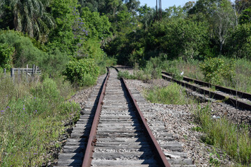 Fototapeta premium Old and abandoned railway and rails with rusty wooden sleepers in Brazil