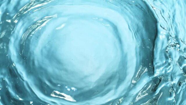 Super Slow Motion Shot of Water Splash at 1000fps Isolated on Ligh Blue Background.