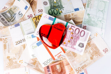 Heart shape on Euro banknotes. The heart lies on the Euro banknotes. Heart with banknotes.