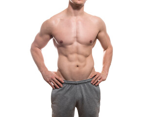 Muscular and fit bodybuilder shirtless torso isolated on white