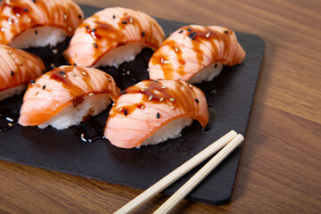 Flambéed salmon nigiri. Restaurant menu