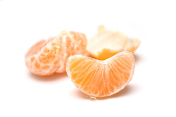 Closeup of peeled tangerine on white background