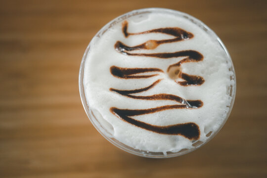 Iced mocha coffee decorated with beautiful art on milk foam