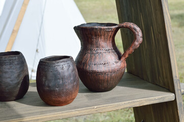 at the fair beautiful handmade clay dishes - a jug, tall cups