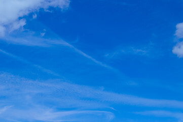 close-up - blurry traces from the flight of the plane on the blue sky and light clouds