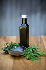 Hemp, with a teacup with hemp tea. It natural ambience that emphasizes the organic character of hemp. A black bottle with hemp oil is also seen. 