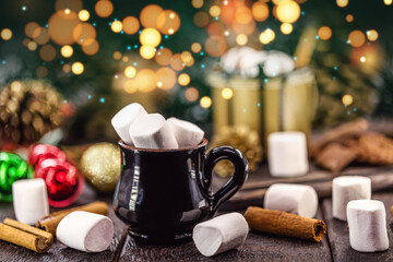 Obraz na płótnie Canvas vintage mug with many marshmallows inside, blurred lights and bokens in the background, decorated christmas setting, cuisine or christmas cuisine typical of united states and europe