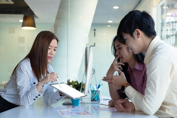 Cropped shot of two UI developers meeting on their project with paperwork and tablet on meeting...