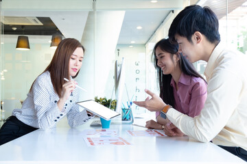 Cropped shot of two UI developers meeting on their project with paperwork and tablet on meeting...