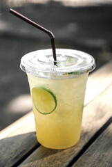 Lemon honey soda in a glass on a wooden table