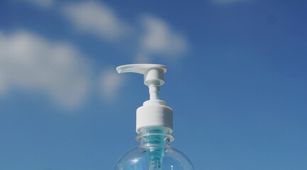 Close-Up a bottle alcohol gel on a sky background.