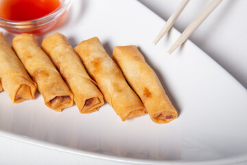 Fried elastic rolls on a white plate