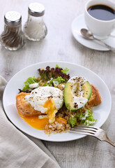 A healthy and balanced breakfast plate.
Benedict's egg spreads on a toasted toast with half an avocado, quinoa and lettuce, seasoned   spices and yogurt dressing. Enjoy the most important meal of the 