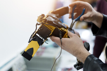 Scientists engineers designing small human robot, setting artificial intelligence humanoid robot. Artificial intelligence, futuristic and smart robots concept.