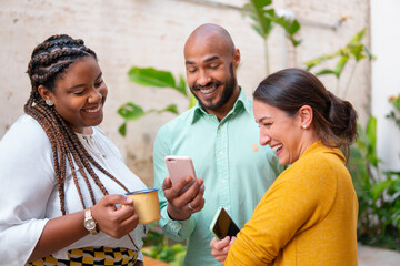 Latin female boss in informal conversation with teammates outside in the garden. Conversation, communication, excited, interaction concept..