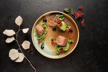 Pork medallion with asparagus and pea puree. Hot meat dish with vegetable garnish.