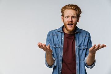 Nervous unshaven redhead guy resenting on camera