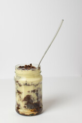 vanilla and chocolate trifle dessert in a glass mason jar 
