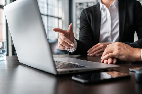 Office Female Manager Finger Pointing On The Laptop Screen. Office Business Collegues Working With Laptop, No Face, Man And Female Managers In Office With Laptop, Concept Of Work