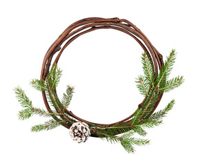 Creative Christmas frame. A circle of willow rods, decorated with spruce branches and a pine cone on a white background isolated. Close up.
