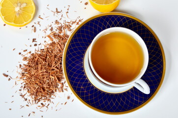 Cup of tea, Catuaba bark and lemon on white background. Natural herbal tea from Catuaba tree bark, natural aphrodisiac from Brasilia