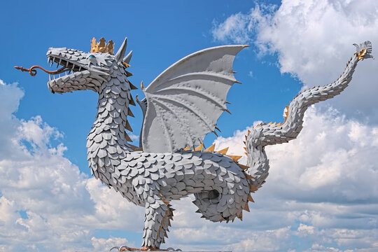 Kazan, Russia. Wrought iron sculpture of Zilant, official symbol of Kazan, on the background of blue sky with cumulus clouds.