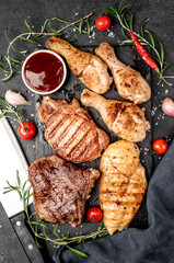 Various types of grilled meat, beef, pork, chicken on stone background	
