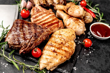 Various types of grilled meat, beef, pork, chicken on stone background	