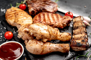 Various types of grilled meat, beef, pork, chicken on stone background	