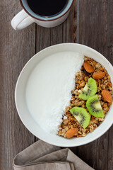 Muesli with white yogurt, kiwi and coconut. Granola. Healthy eating. Vegetarian food. Breakfast.