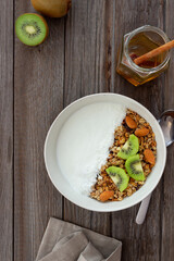 Muesli with white yogurt, kiwi and coconut. Granola. Healthy eating. Vegetarian food. Breakfast.