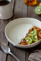 Muesli with white yogurt, kiwi and coconut. Granola. Healthy eating. Vegetarian food. Breakfast.