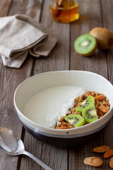 Muesli with white yogurt, kiwi and coconut. Granola. Healthy eating. Vegetarian food. Breakfast.