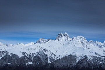 Fototapeta na wymiar Panoramic view on high snowy mountains in winter at sunny day. Caucasus Mountains, Mount Ushba. Svaneti region of Georgia