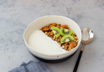Muesli with white yogurt, kiwi and coconut. Granola. Healthy eating. Vegetarian food. Breakfast.