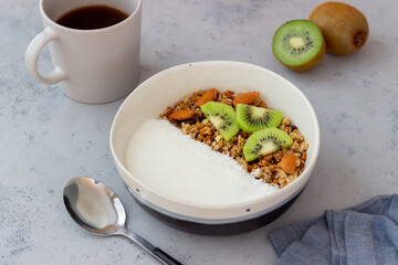 Muesli with white yogurt, kiwi and coconut. Granola. Healthy eating. Vegetarian food. Breakfast.