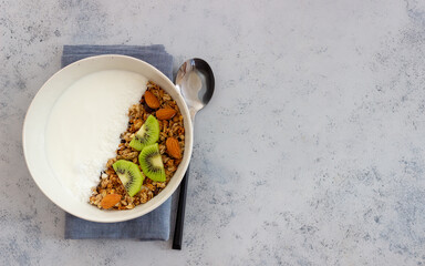 Muesli with white yogurt, kiwi and coconut. Granola. Healthy eating. Vegetarian food. Breakfast.