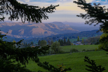Mountains landscape during sunset sky across fir tree branches frame. natural background. Copy space. Travel, trekking, hiking, camping concept