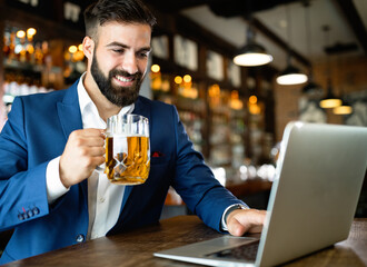 Handsome business man using laptop at his work break in restaurant