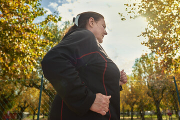 Active senior woman doing healthy exercises outdoors. Jogging