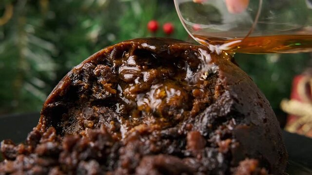 Christmas pudding pours alcohol and set on fire. British traditional food