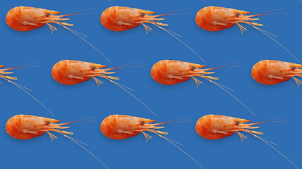 Juicy fresh shrimp seamless pattern isolated on blue background. Place for your text. Seamless pattern of shrimps on a blue background. Background texture of seafood shrimps.