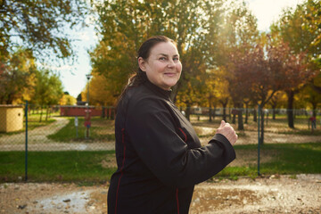 Active senior woman doing healthy exercises outdoors. Jogging