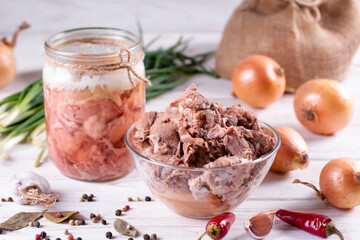 Pork stew in a jars on a white wooden background. Ukrainian, homemade stew.