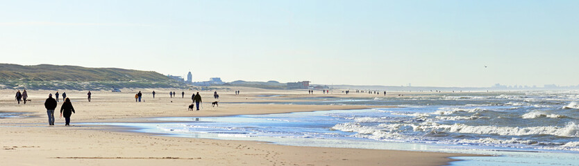Social distance on the beach: people having a walk on a windy day during the Covid lock-down in autumn 2020; Noordwijk, the Netherlands